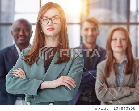 Portrait of a confident young businesswoman standing with her arms crossed in an office 107840859