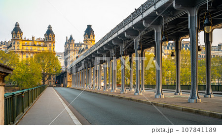 Promenade Jean-Paul Belmondo. Long row of metal columns of elevated subway. Bir Hakeim Bridge in Paris, France 107841189