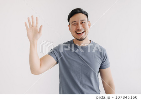 Happy asian man pop out for greeting and say hi, stand isolated on white 107845160