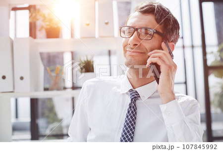 Man accountant or business lawyer talking on smartphone Man accountant or business lawyer talking on smartphone 107845992