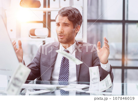 Shocking news. Surprised young man in a suit and tie looking at Shocking news. Surprised young man in a suit and tie looking at 107846019