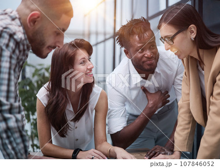 Group of young business people working together while standing in creative office Group of young business people working together while standing in creative office 107846052