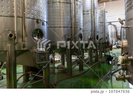 Interior of winery with stainless steel tanks 107847836