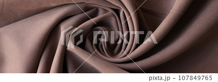 Twisted brown textile with creases for curtain production Twisted brown textile with creases for curtain production 107849765