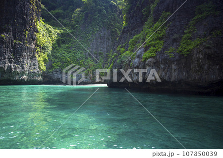 Thai traditional wooden longtail boat and beautiful sand Railay Beach in Krabi Thai traditional wooden longtail boat and beautiful sand Railay Beach in Krabi 107850039