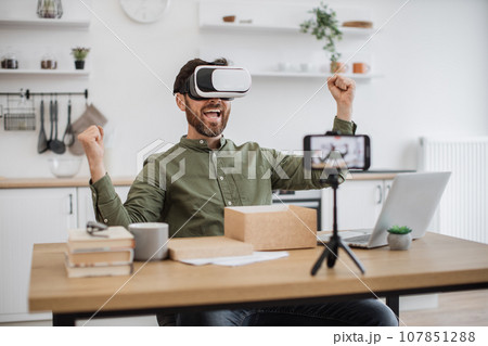Smartphone recording video of blogger testing VR headset 107851288