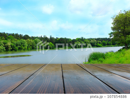 wooden boards with view to forest lake wooden boards with view to forest lake 107854886