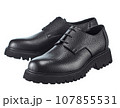 Amazing pair of men's derby boots made of pimpled dense black leather with lacing, on a high powerful sole, isolated on a white background. 107855531