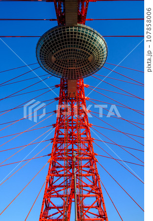 View of a cable-stayed bridge element against a blue sky. 107858006