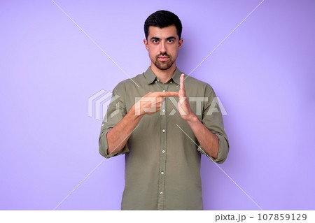 attractive man showing number 100 with finger and palm, hand 107859129