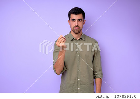 Young deaf mute man asking money using sign language on blue background Young deaf mute man asking money using sign language on blue background 107859130
