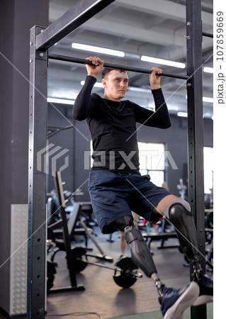 confident sportsman concentrated on working out with bar 107859669