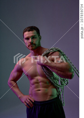 sexy shirtless strong man with perfect abs holding battle ropes sexy shirtless strong man with perfect abs holding battle ropes 107859734