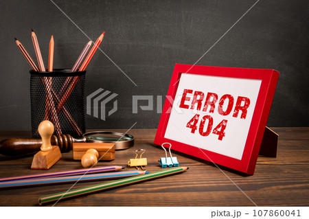 Error 404. A picture frame on a wooden office table 107860041