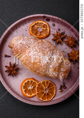 Delicious fresh sweet crispy croissants with chocolate cream on a ceramic plate Delicious fresh sweet crispy croissants with chocolate cream on a ceramic plate 107860250