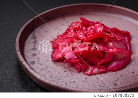 Delicious spicy pink cabbage sliced and cooked in Korean style on a ceramic plate Delicious spicy pink cabbage sliced and cooked in Korean style on a ceramic plate 107860272