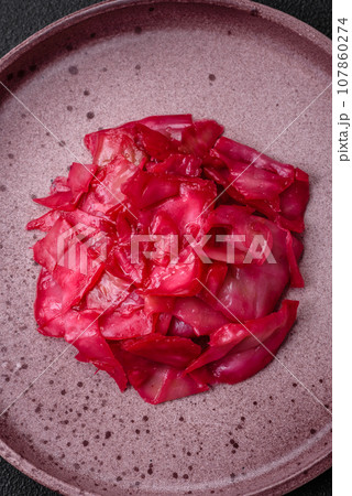 Delicious spicy pink cabbage sliced and cooked in Korean style on a ceramic plate Delicious spicy pink cabbage sliced and cooked in Korean style on a ceramic plate 107860274