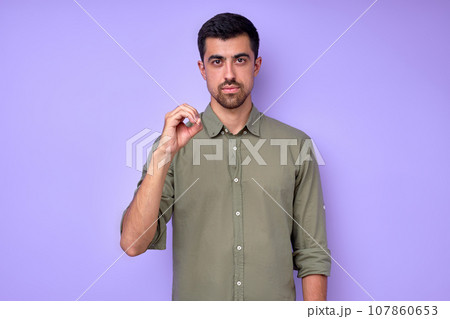 serious handsome man showing letter O o with fingers serious handsome man showing letter O o with fingers 107860653