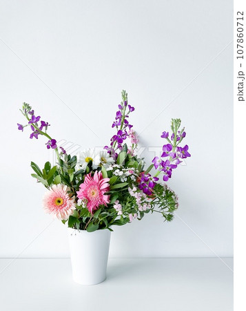 bouquet flowers in white vase. dianthus. daylight 107860712