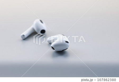 Pair of white wireless headphones on grey background, modern device to listen music or talk 107862380