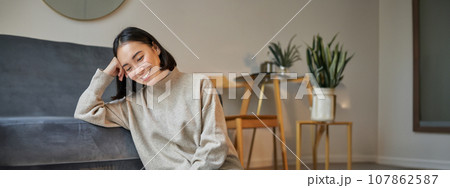 Vertical shot of beautiful asian woman, student sitting at home and studying remotely, elearning with laptop Vertical shot of beautiful asian woman, student sitting at home and studying remotely, elearning with laptop 107862587
