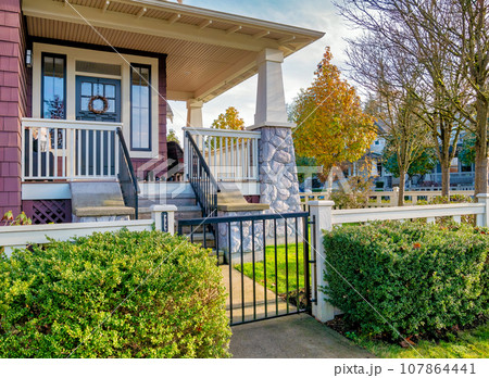A perfect neighbourhood. Main entrance of a luxury residential house A perfect neighbourhood. Main entrance of a luxury residential house 107864441