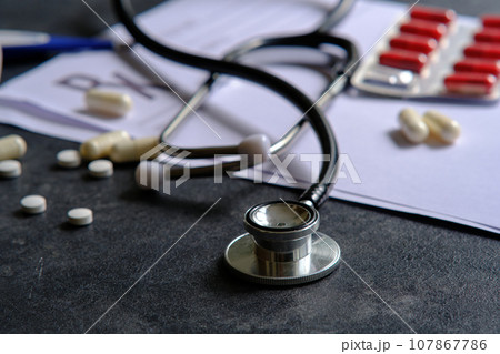 medical stethoscope on a dark background medical stethoscope on a dark background 107867786