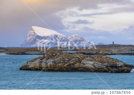 Sommaroy islands and arctic sea near Tromso Norway. Sunset over snowy small islands Sommaroy islands and arctic sea near Tromso Norway. Sunset over snowy small islands 107867850