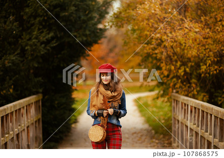 pensive young female in jeans shirt and red hat pensive young female in jeans shirt and red hat 107868575