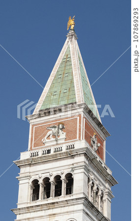 Piazza San Marco with top of Campanile di San Marco with golden angel on top at City of Venice on sunny summer day. Piazza San Marco with top of Campanile di San Marco with golden angel on top at City of Venice on sunny summer day. 107869293