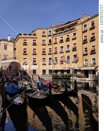 Canal with gondolas in Venice, Italy. Architecture and landmarks of Venice. Postcard with gondola. Canal with gondolas in Venice, Italy. Architecture and landmarks of Venice. Postcard with gondola. 107870157