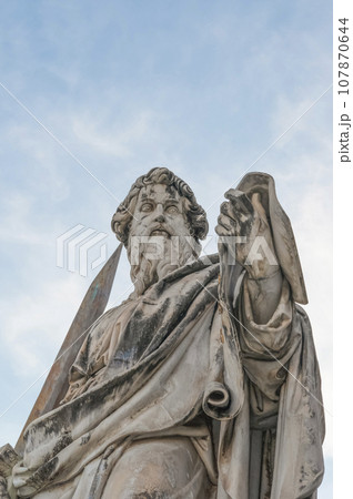 Bottom view close up of Saint Paul statue in front of the Basilica of St Peter in Vatican Bottom view close up of Saint Paul statue in front of the Basilica of St Peter in Vatican 107870644
