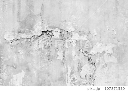 Old wall with deep cracks. Grunge gray color texture. Destruction on the surface of the wall. 107871530