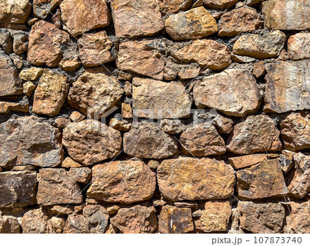 Old stone wall background. Ancient stonewall texture 107873740