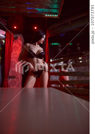 Alluring woman in underwear standing in sauna and looking away 107873795