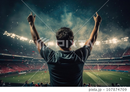 Backlit Soccer Player Stands Tall in Front of Stadium 107874709