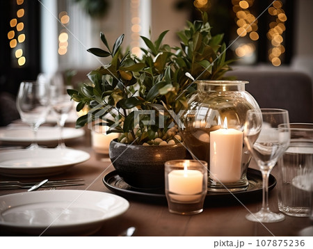 Winter holiday season festive dining table decoration with candles and beautiful tableware, elegant table decor Winter holiday season festive dining table decoration with candles and beautiful tableware, elegant table decor 107875236