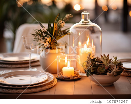 Winter holiday season festive dining table decoration with candles and beautiful tableware, elegant table decor Winter holiday season festive dining table decoration with candles and beautiful tableware, elegant table decor 107875247