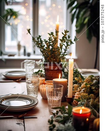 Winter holiday season festive dining table decoration with candles and beautiful tableware, elegant table decor Winter holiday season festive dining table decoration with candles and beautiful tableware, elegant table decor 107875248