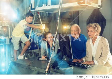 Grandparents and grandchildren resolveing riddles in escape room Grandparents and grandchildren resolveing riddles in escape room 107879345