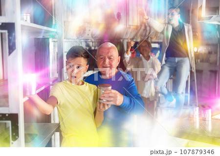 Grandson together with his grandfather solve the riddles of quest room 107879346