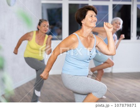 Group of elderly woman dancing in fitness studio 107879871