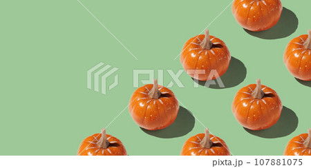 Orange pumpkin pattern on pastel color background 107881075