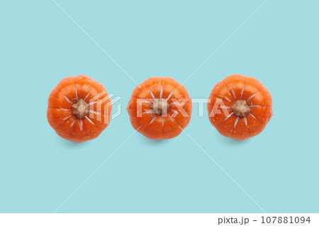 Three orange pumpkins on pastel color background 107881094