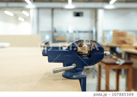 Bench vice installed on table equipment for carpentry work Bench vice installed on table equipment for carpentry work 107885309