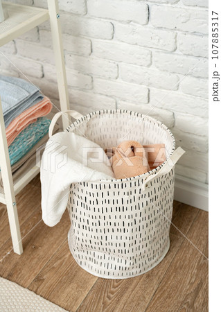 Fabric laundry basket in a bathroom close up 107885317