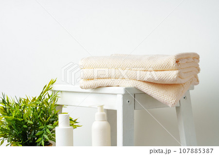 Stacked clean fluffy towels in a bathroom 107885387
