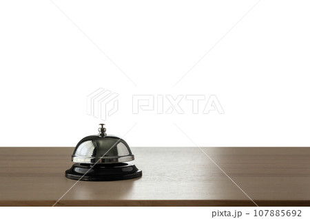 Hotel service bell on wood counter isolated on white background 107885692