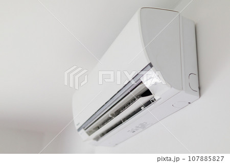 Air conditioner on white wall room interior background Air conditioner on white wall room interior background 107885827