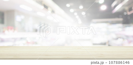 Wood table top with supermarket grocery store blurred background with bokeh light for product display 107886146